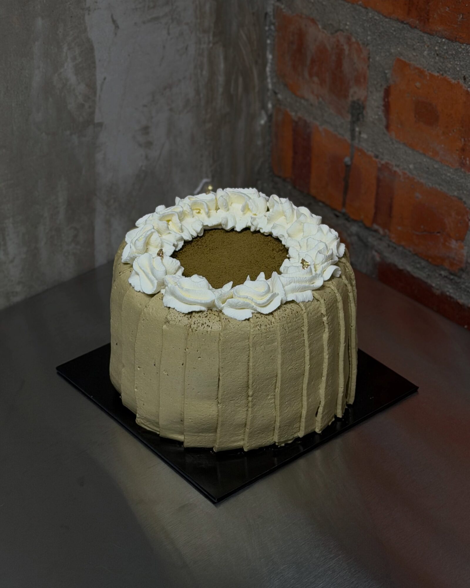 Hojicha Cake on a black cake board