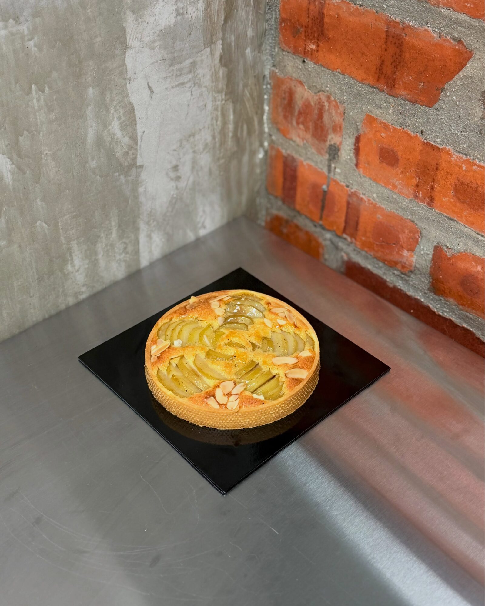 Pear Tart on a black cake board